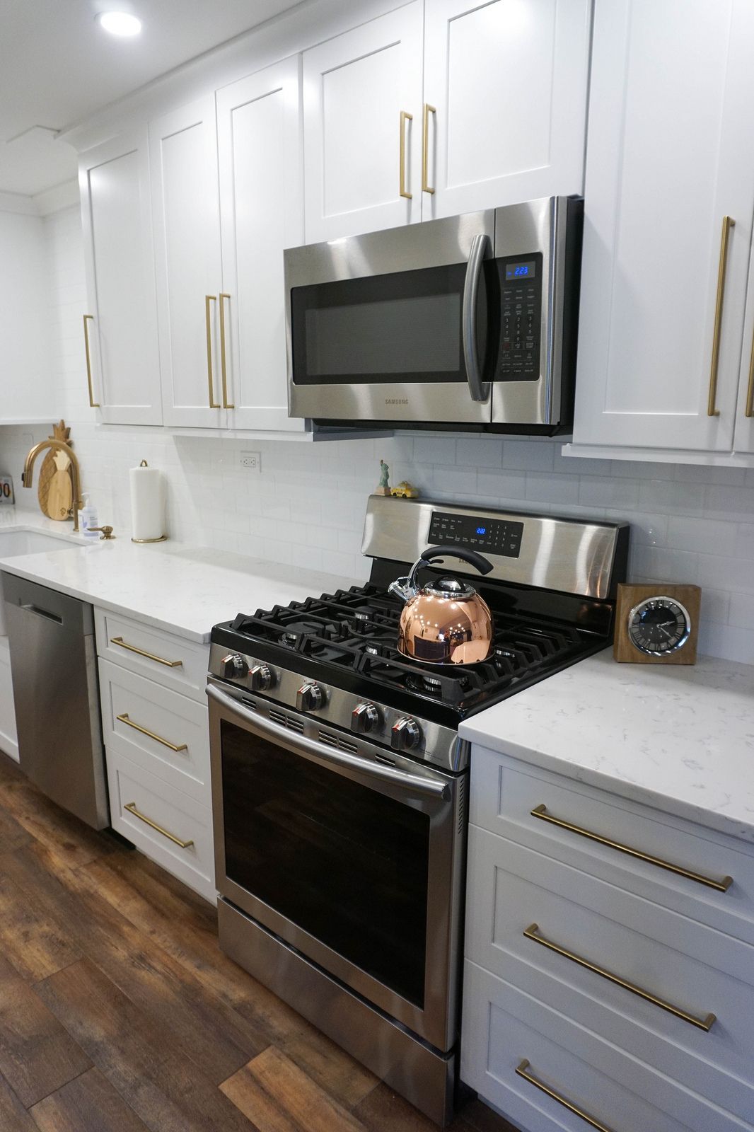 gold kitchen hardware with stainless appliances